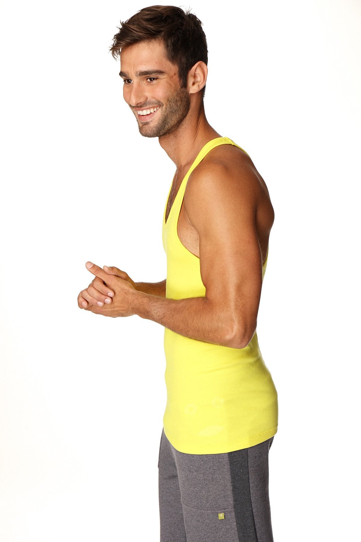 Bright yellow fitted sleeveless racerback yoga tank top with athletic cut designed for active wear