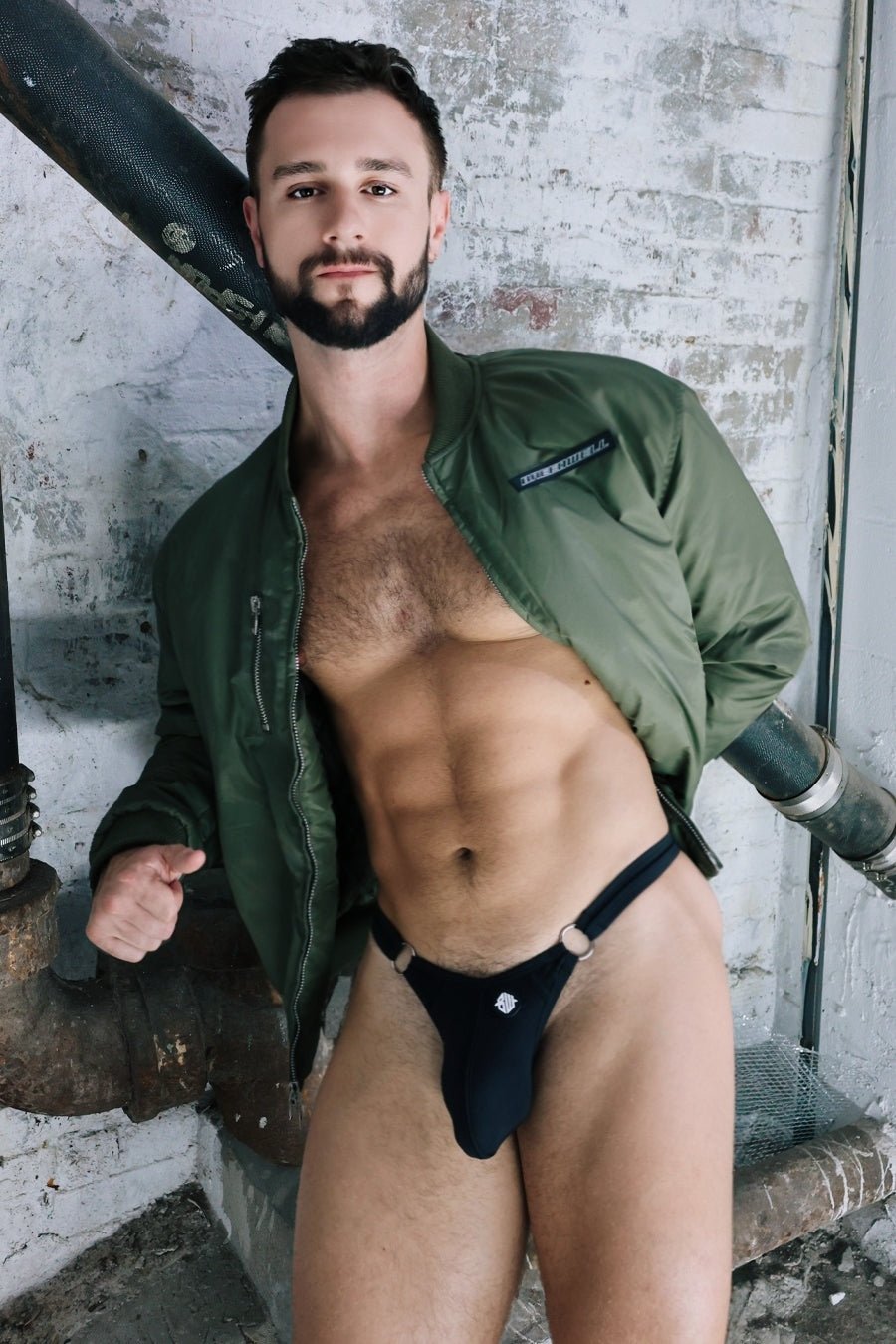 Black thong with a small white logo on the front from the renegade bomber collection