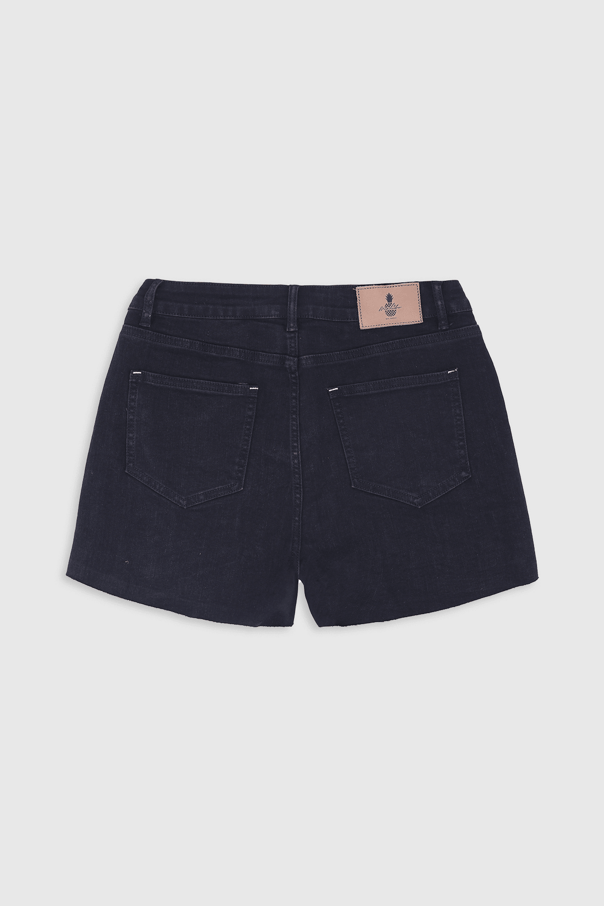 Black denim rockstar raw cut 2.5 inch shorts with subtle faded wash and small light brown leather brand patch at waistband