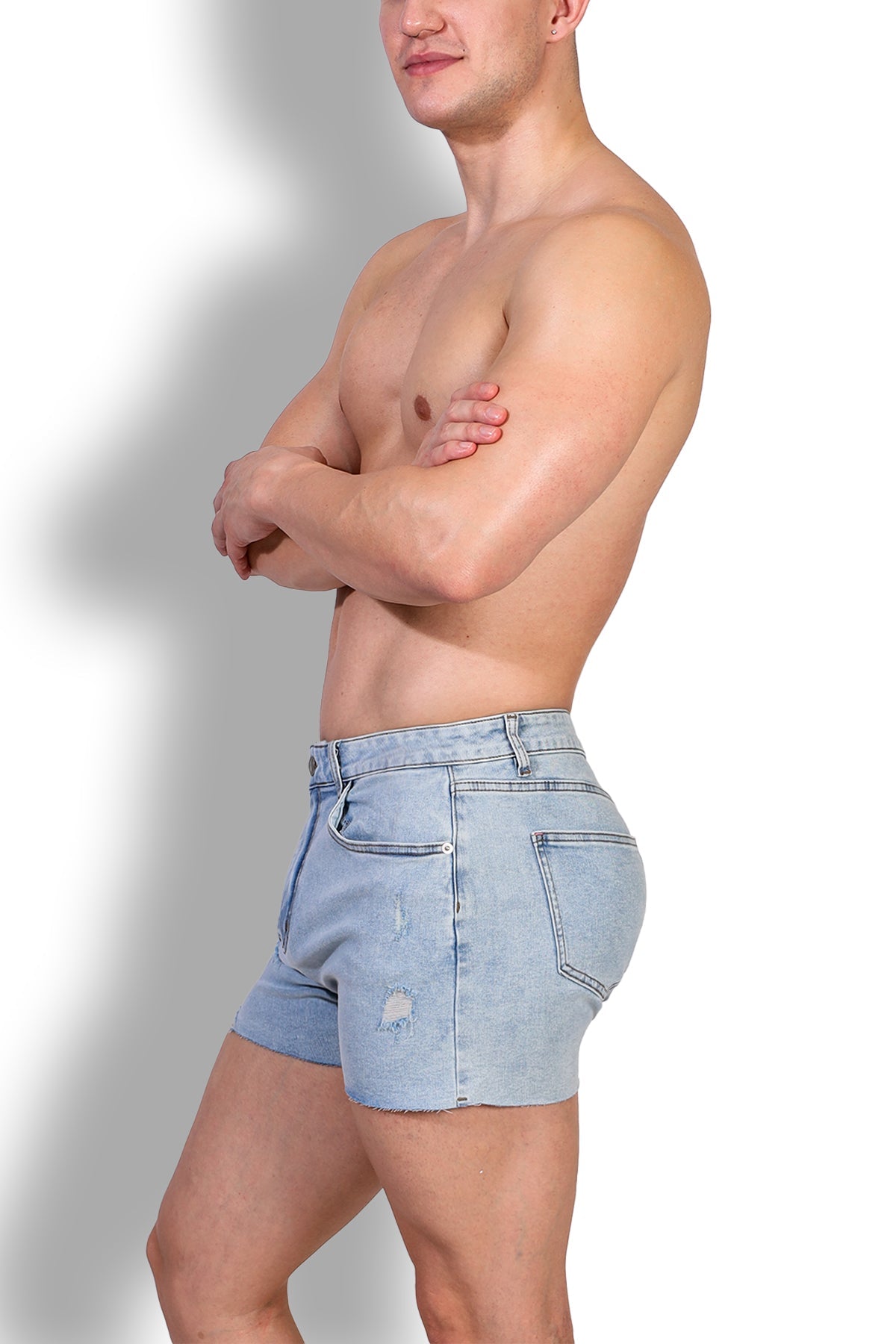 Rockstar raw cut 2.5 inch light-wash denim short shorts with distressed patch on left thigh and raw hem in capri blue
