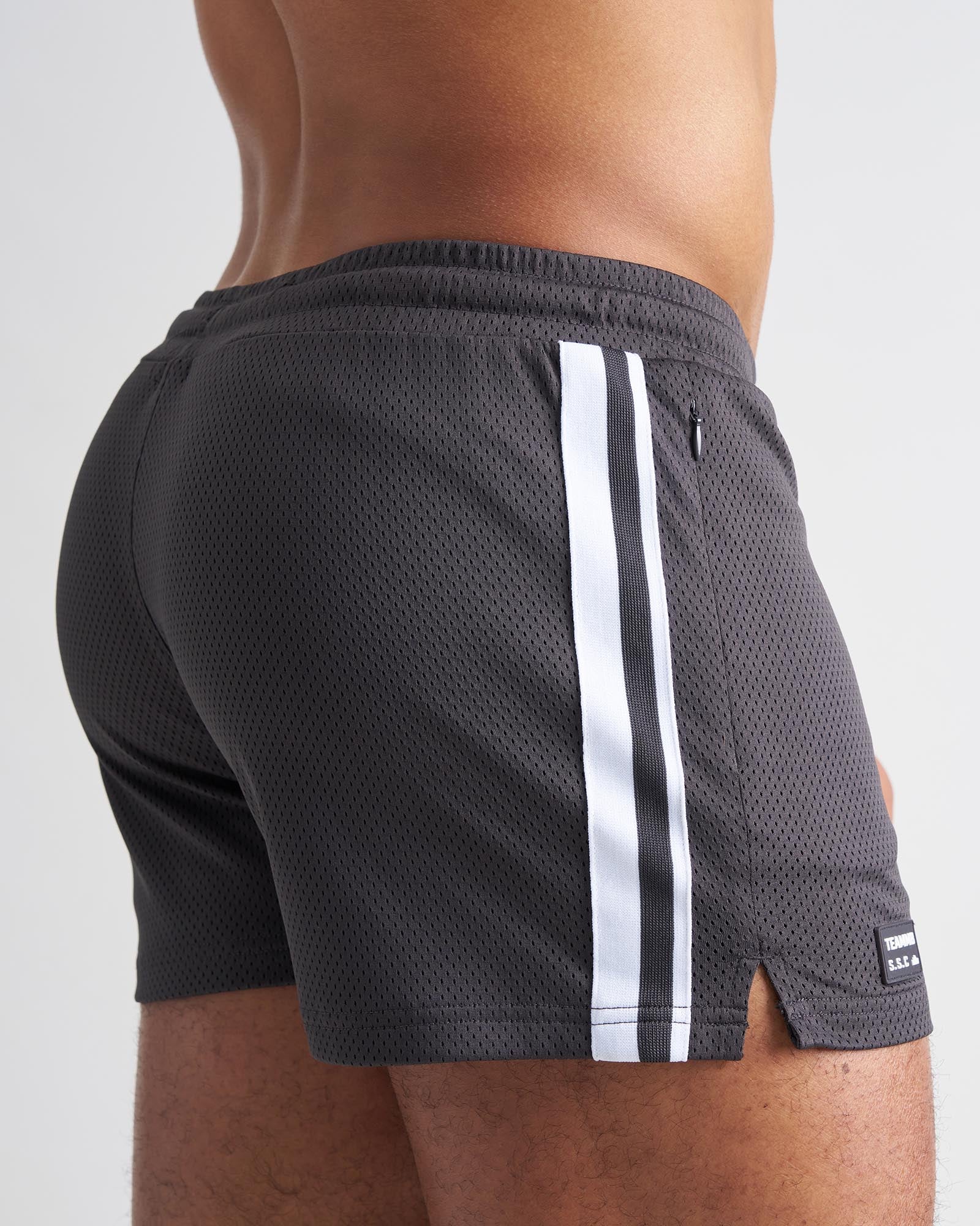 Dark gray mesh s.s.c. fraternity 3 inch athletic shorts with two white vertical stripes and black brand tag at hem