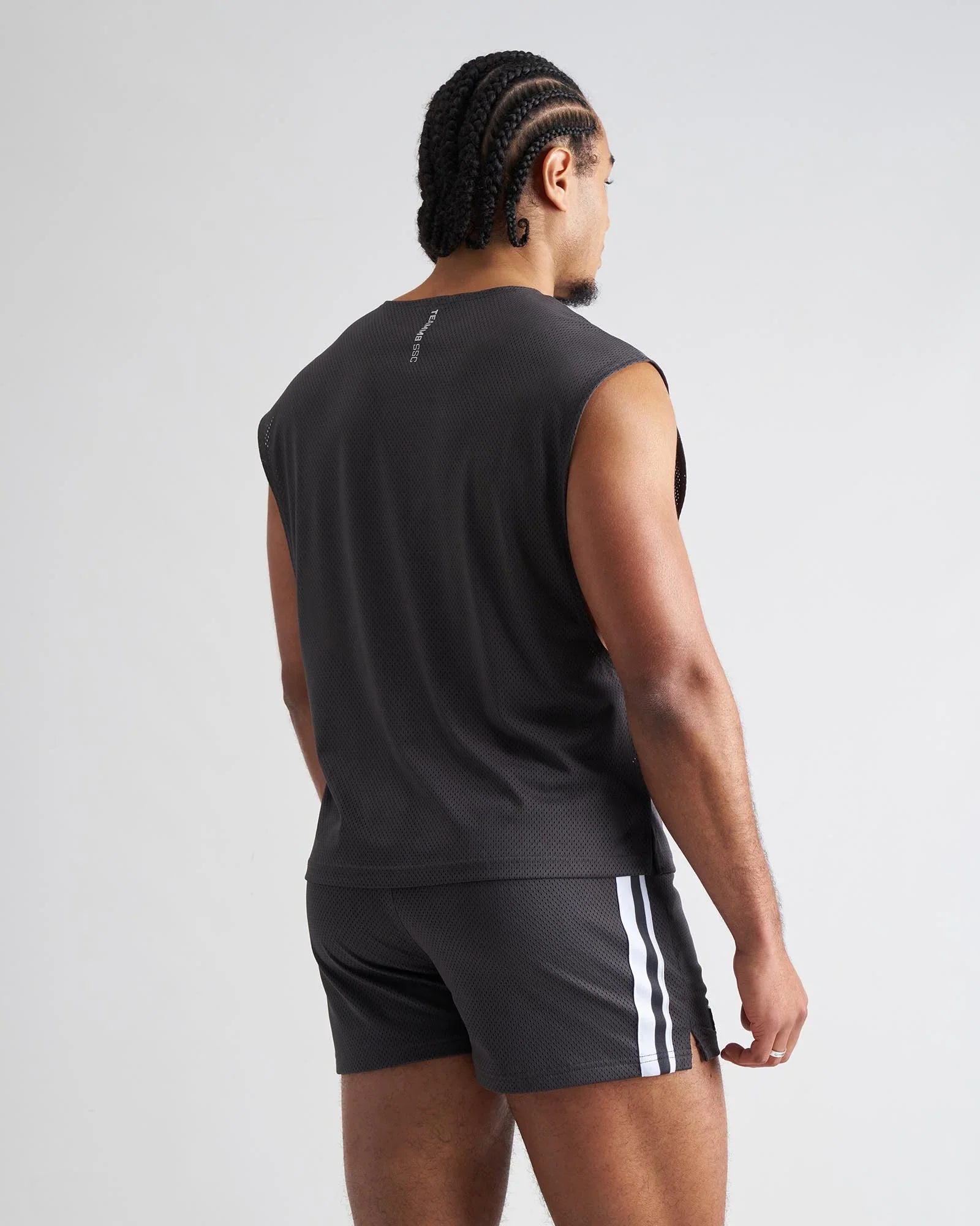 Black sleeveless s.s.c. mesh muscle tank showing the back with textured mesh fabric and subtle branding detail