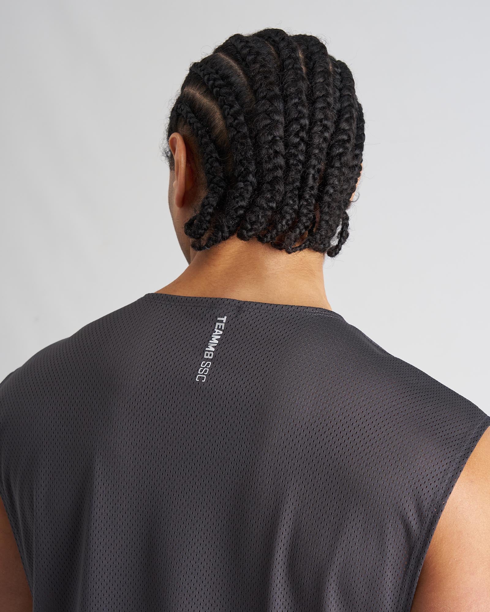 Dark gray mesh sleeveless athletic top s s c mesh muscle tank with team b ssc branding on the back neck view
