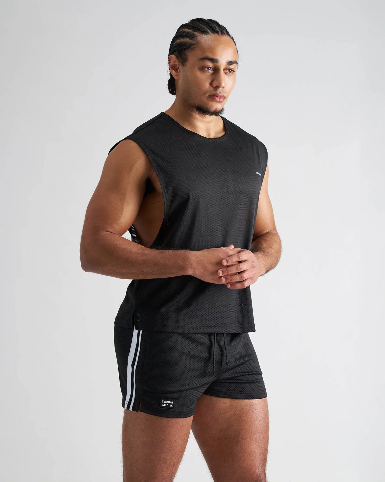 Black sleeveless athletic tank top with textured mesh fabric and subtle side vents s s c mesh muscle tank