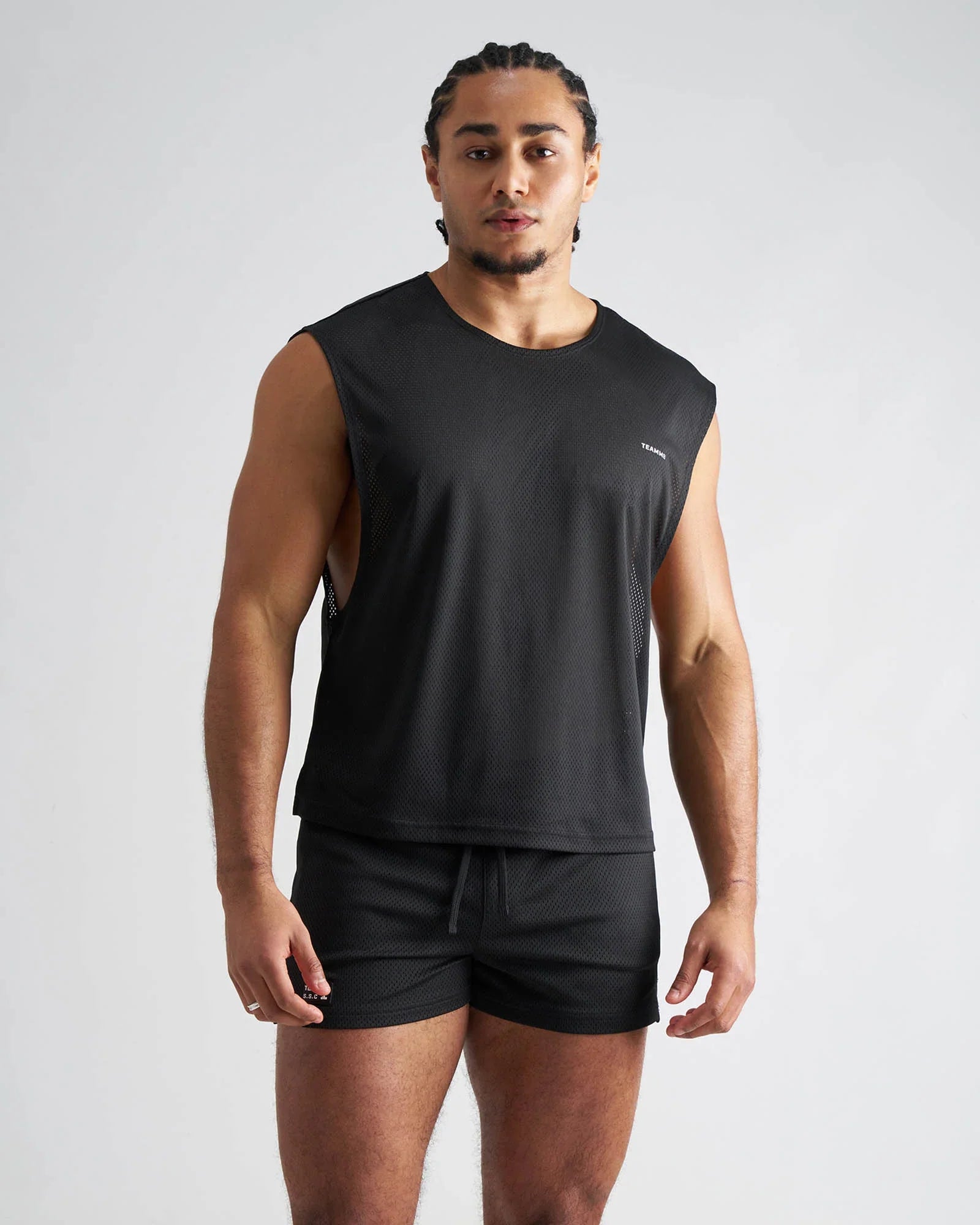 Black sleeveless s.s.c. mesh muscle tank with breathable mesh panels and subtle brand logo on the chest