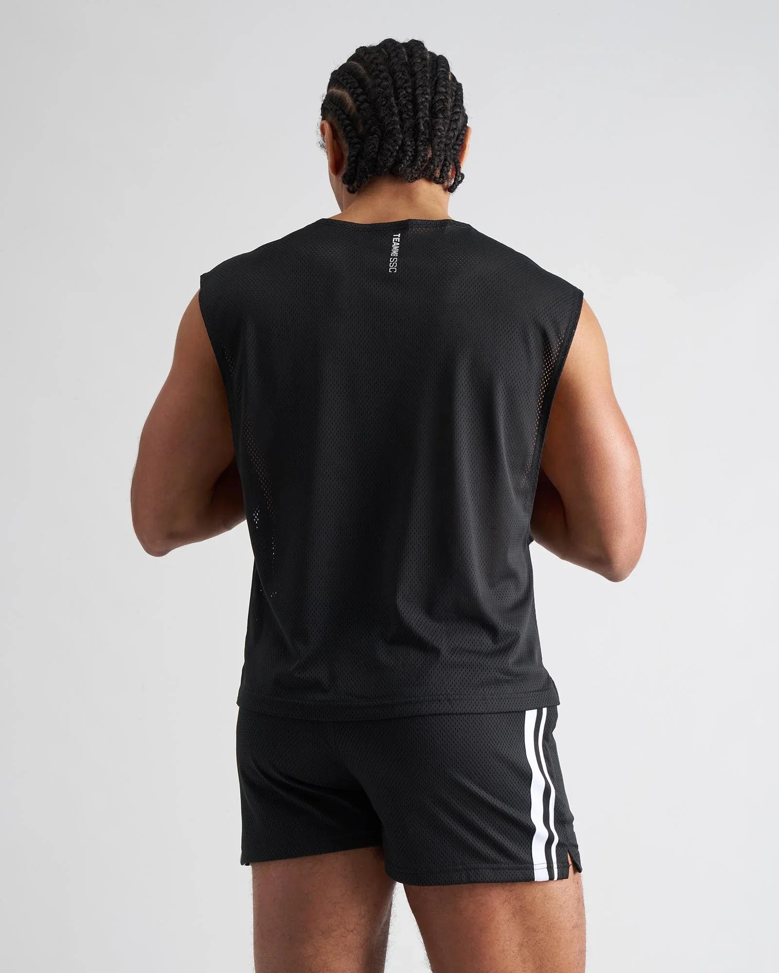 Black mesh sleeveless athletic muscle tank with subtle vertical logo on the back for breathable performance