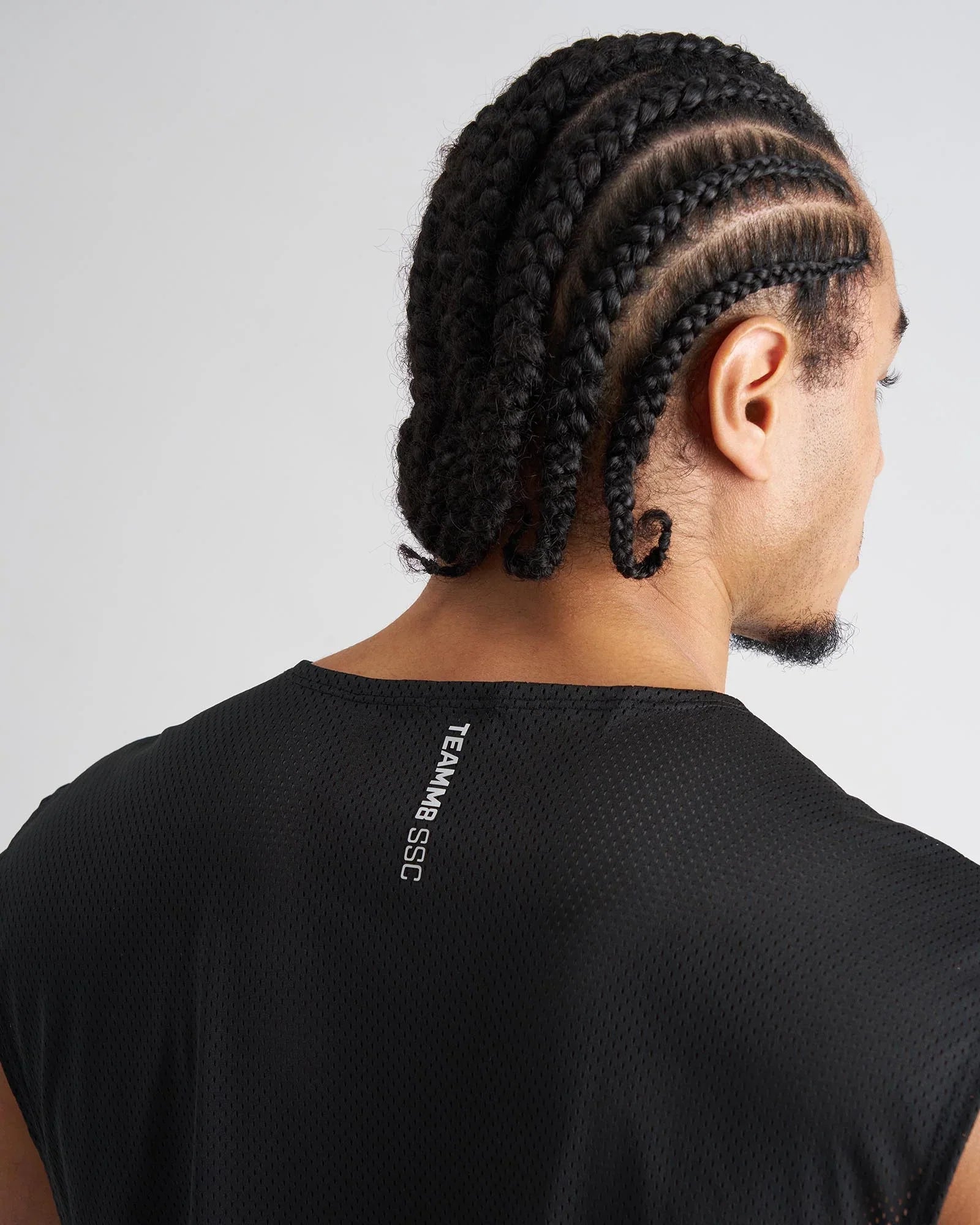 Back side of black mesh sleeveless ssc muscle tank with teammb ssc branding for athletic use