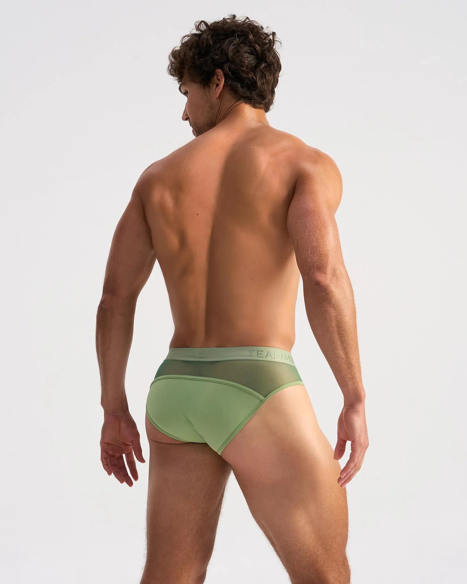 Light green score sheer brief with form-fitting fit, subtle mesh back panel, and elastic waistband with faint branding