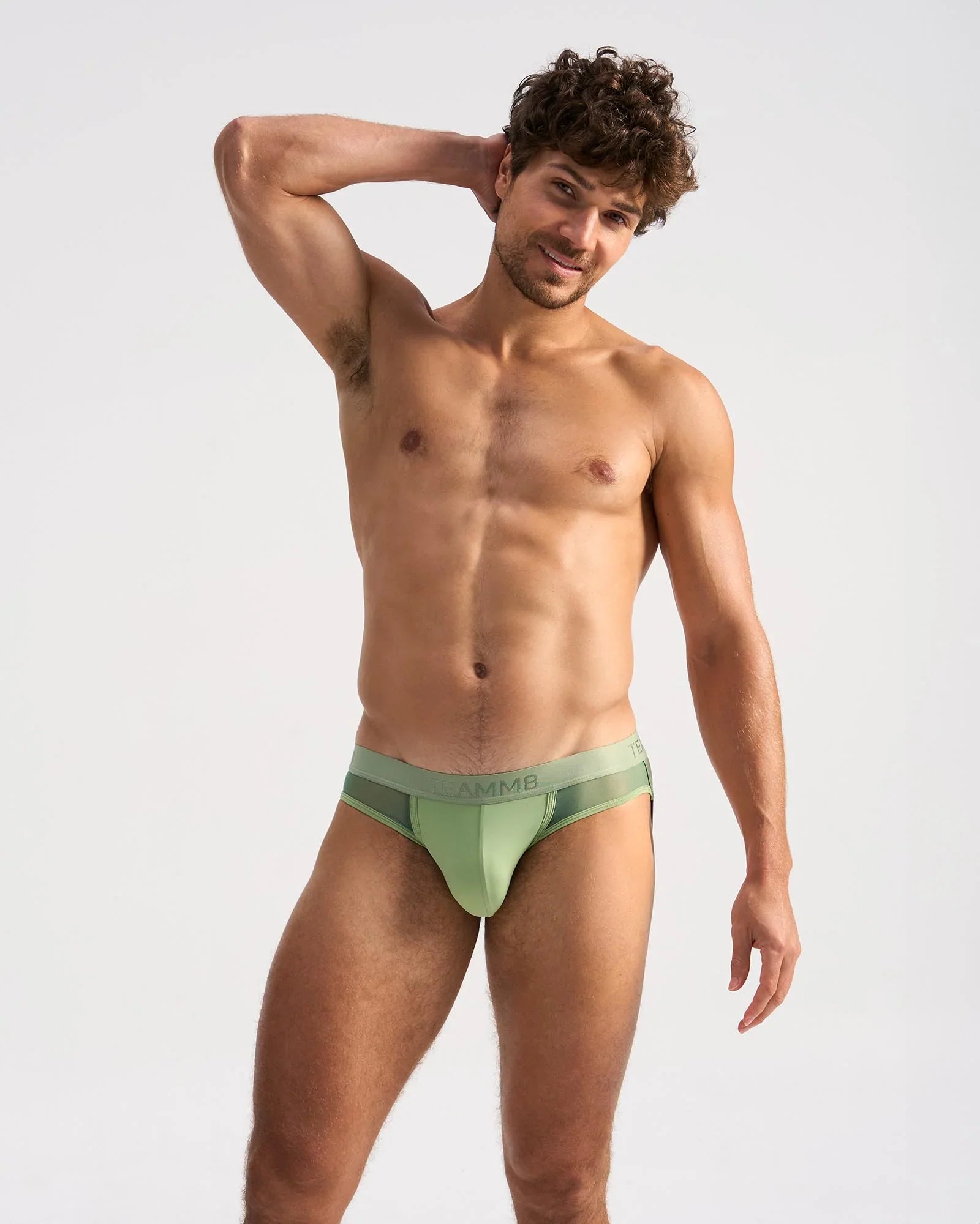 A sleek light green score sheer jock athletic brief with subtle mesh panel and hmb logo on the waistband
