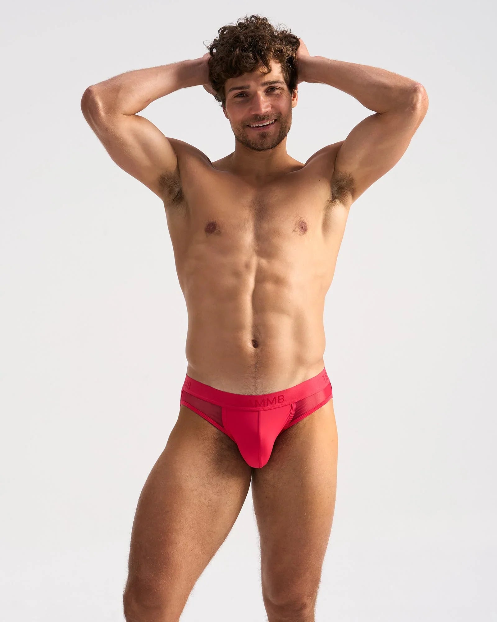 Bright red mesh-textured men’s SCORE SHEER JOCK briefs with sleek modern design and subtle waistband logo embroidery