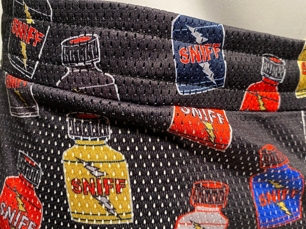 Black mesh fabric bag with colorful cartoon bottles labeled sniff in red yellow and blue for sniff print booty short