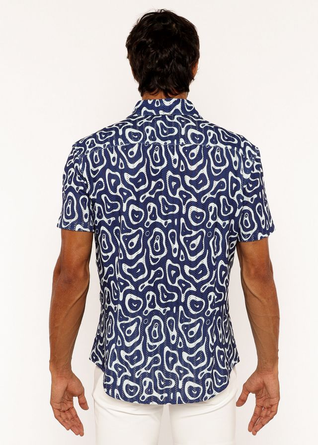 A navy blue short-sleeved open knit shirt with a bold white squiggly print pattern and button-up front