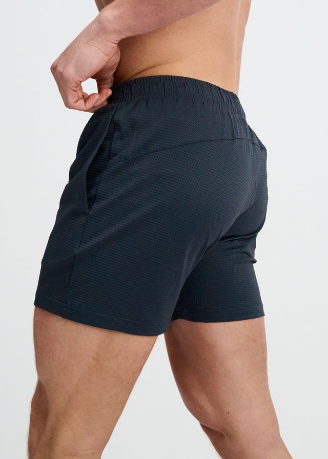 ST33LE Textured Mesh Stretch Performance Shorts in dark charcoal grey, shown from the side with elastic waistband.