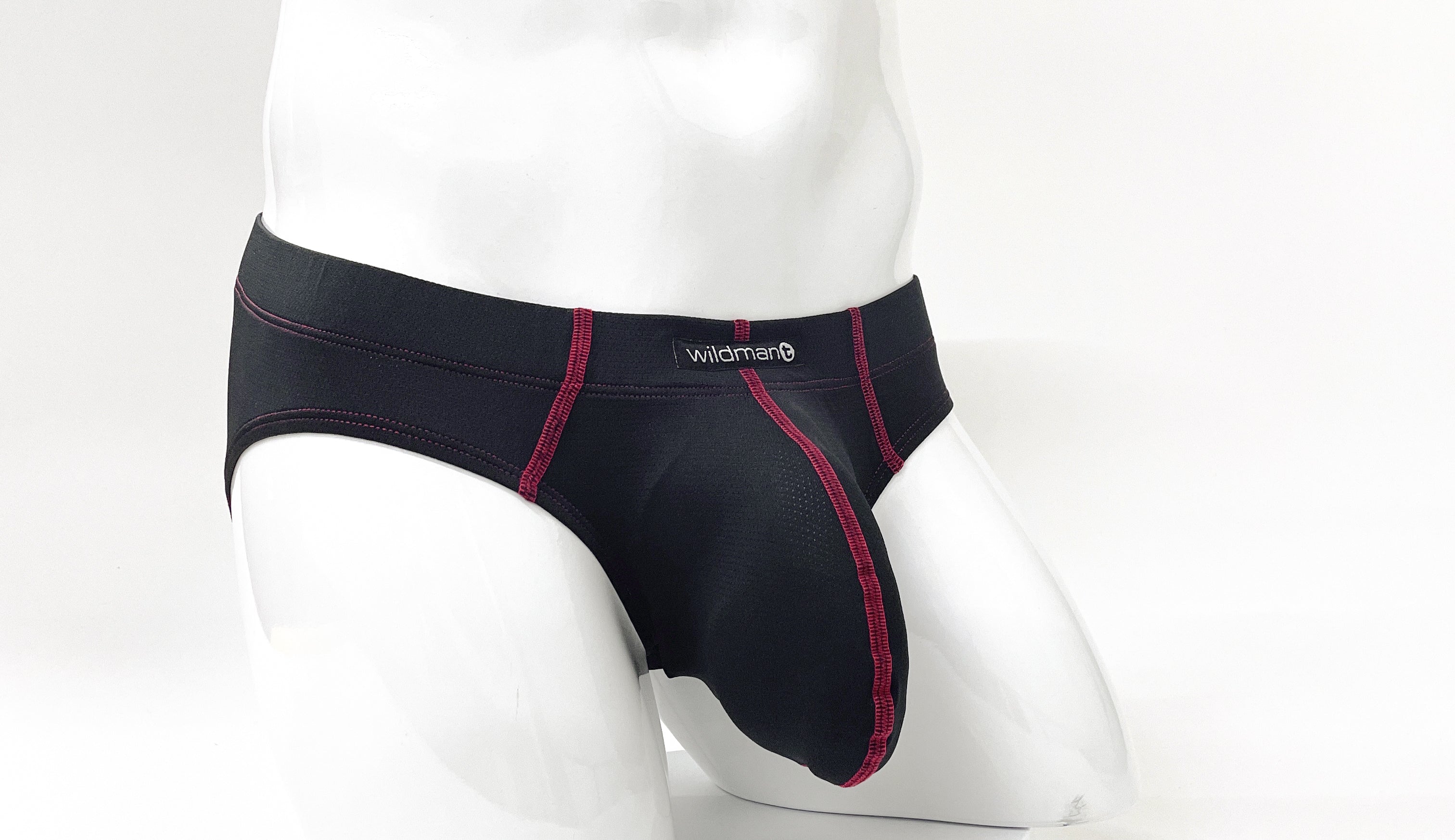 Black pouch brief with red contrast stitching and Wildman logo on the waistband, shown on a white mannequin.