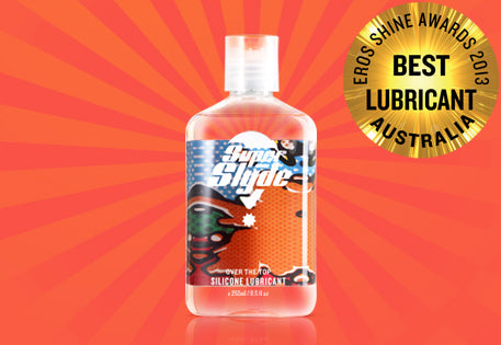 Clear plastic bottle of superslyde silicone lubricant with white cap and colorful label featuring cartoon characters