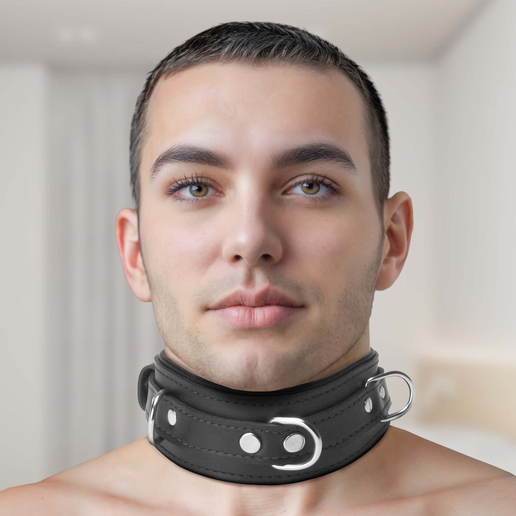 Strict Leather Premium Locking Collar: A man wearing a wide, black leather collar with silver hardware and metal rings.