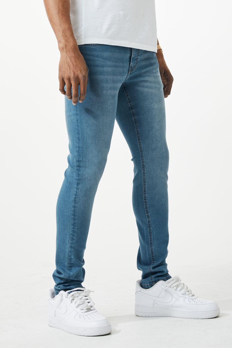 Blue skinny fit denim jeans with slim fit cut five-pocket design and subtle fading made of denim material