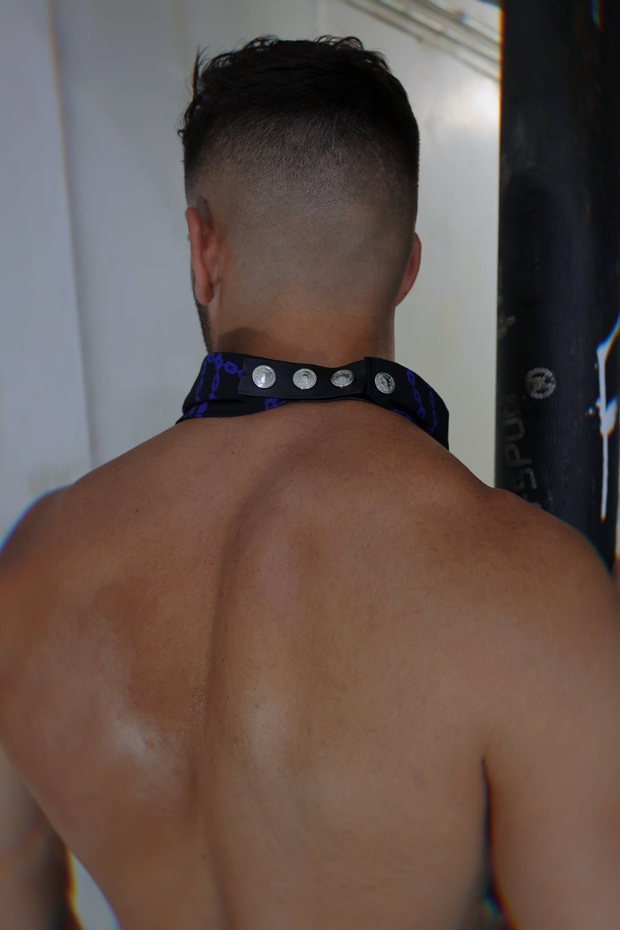 Slay-kerchief bound black and purple patterned neck strap with silver-toned circular studs for stylish wear