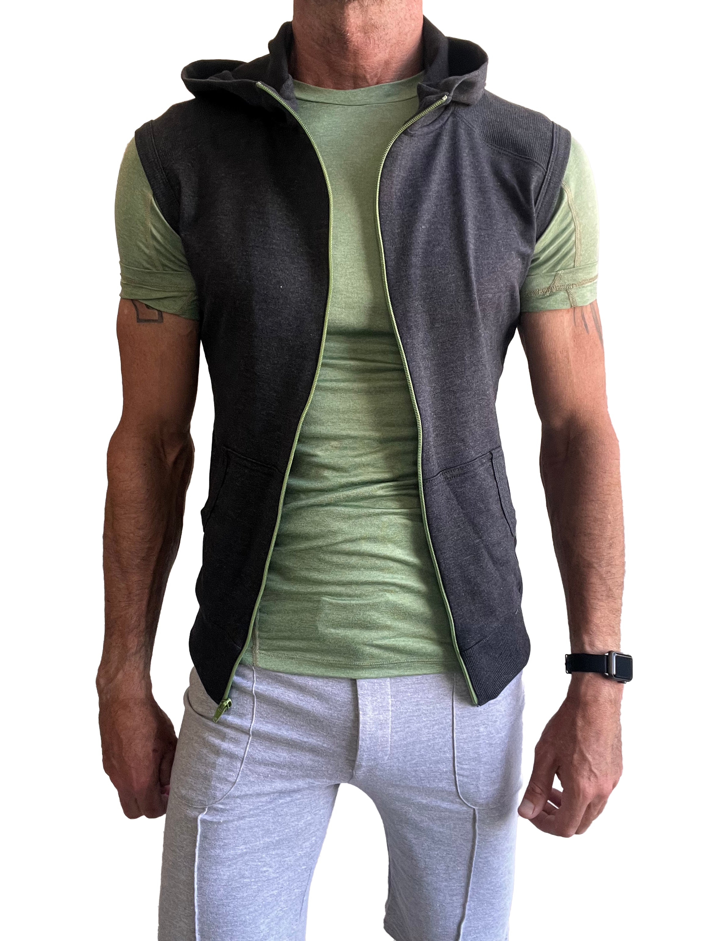 Dark gray sleeveless yoga hoodie vest with light green zipper and lining worn over olive green t-shirt for workout use