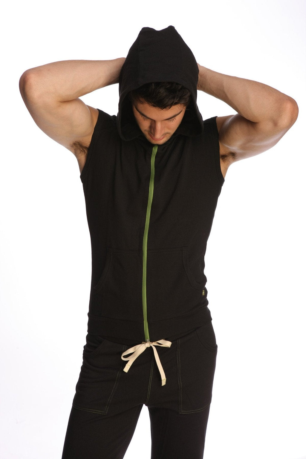 Black sleeveless yoga hoodie with green zipper and beige drawstring at the waist for comfortable workouts