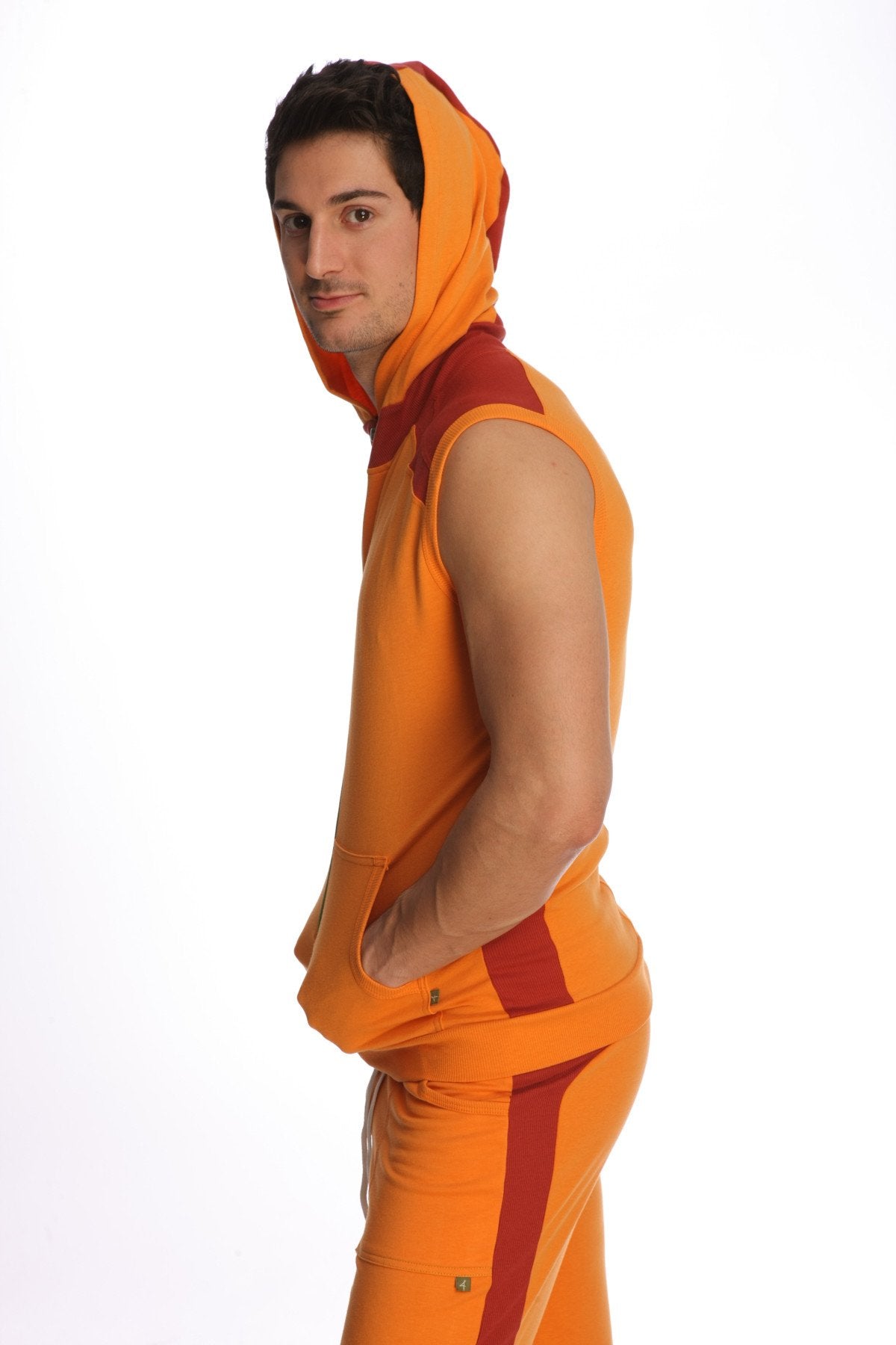 Orange and red sleeveless yoga hoodie with bold color blocking and matching pants in sun orange for active wear