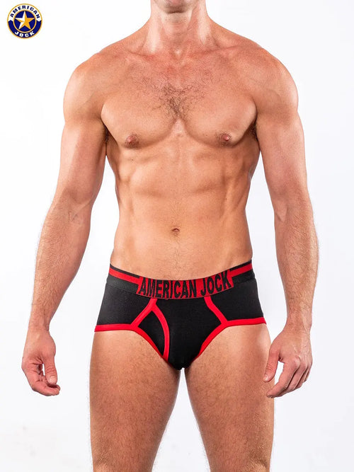 Men's black gym briefs with red accents and logo waistband shown on a model by AMERICAN JOCK.