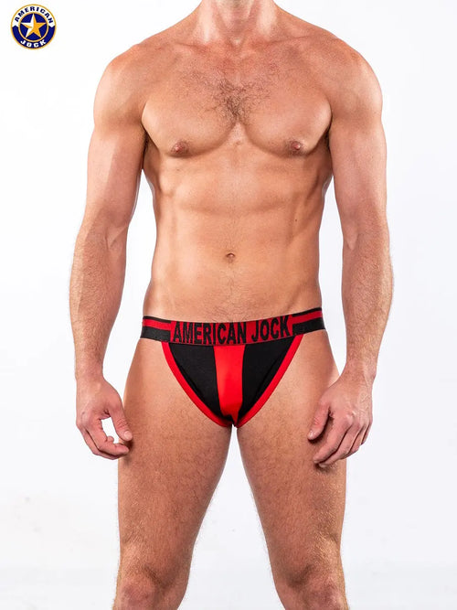 Men's jockstrap in black and red featuring a wide waistband with 'AMERICAN JOCK' logo made from stretchy fabric.