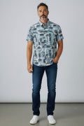 A man wearing a suslo crinkled fabric short-sleeved shirt with an abstract gray and white geometric pattern