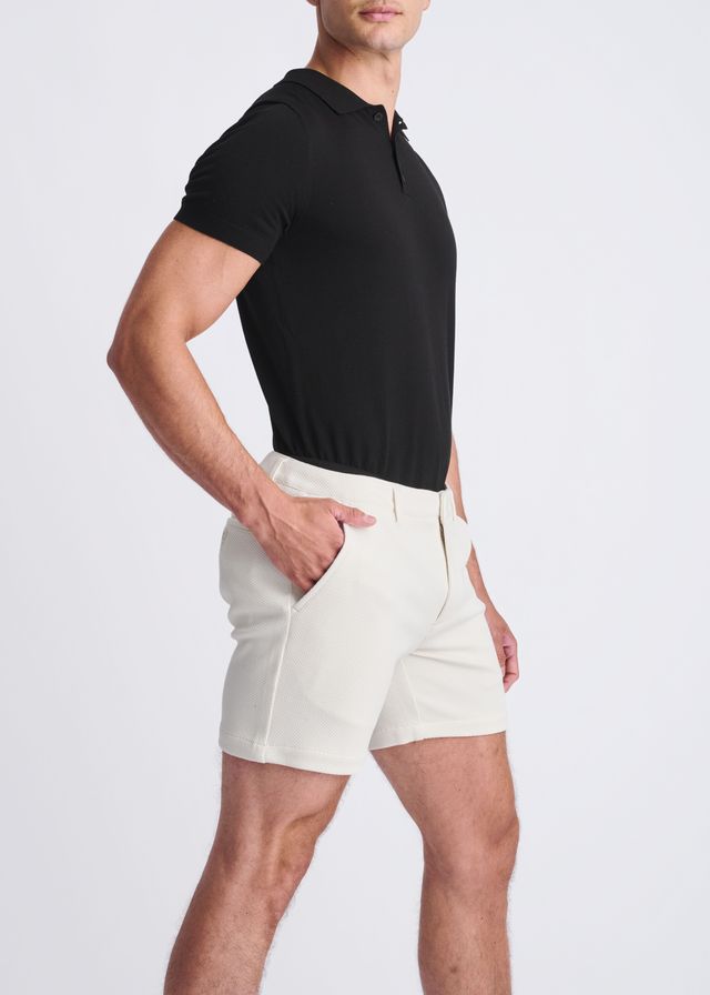 Cream-colored textured stretch knit chino shorts with a modern cut and subtle side seam detailing