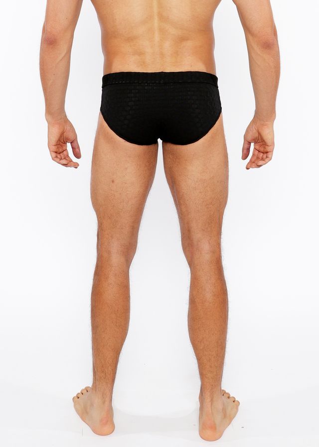 Black textured swim brief with front buckle made of textured fabric for swimming and beachwear use