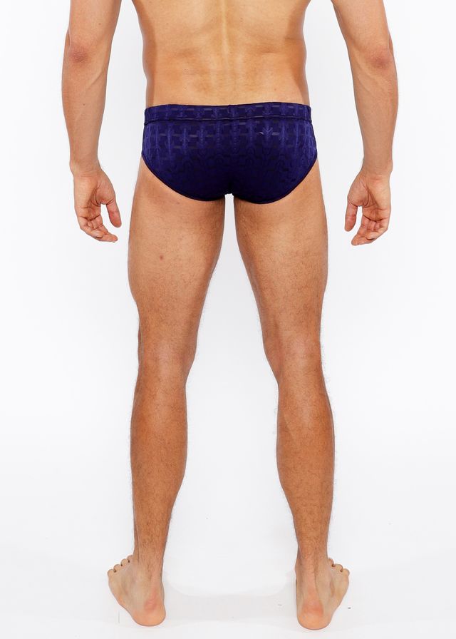 Navy blue textured swim brief with repeating geometric pattern and front buckle for stylish swimwear use