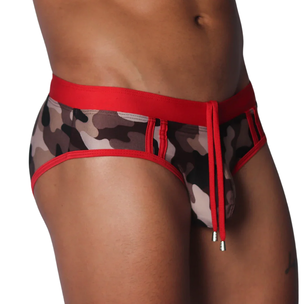 Sheer camo print swim brief with a red elastic waistband, matching trim, and front drawstring with metallic toggles.