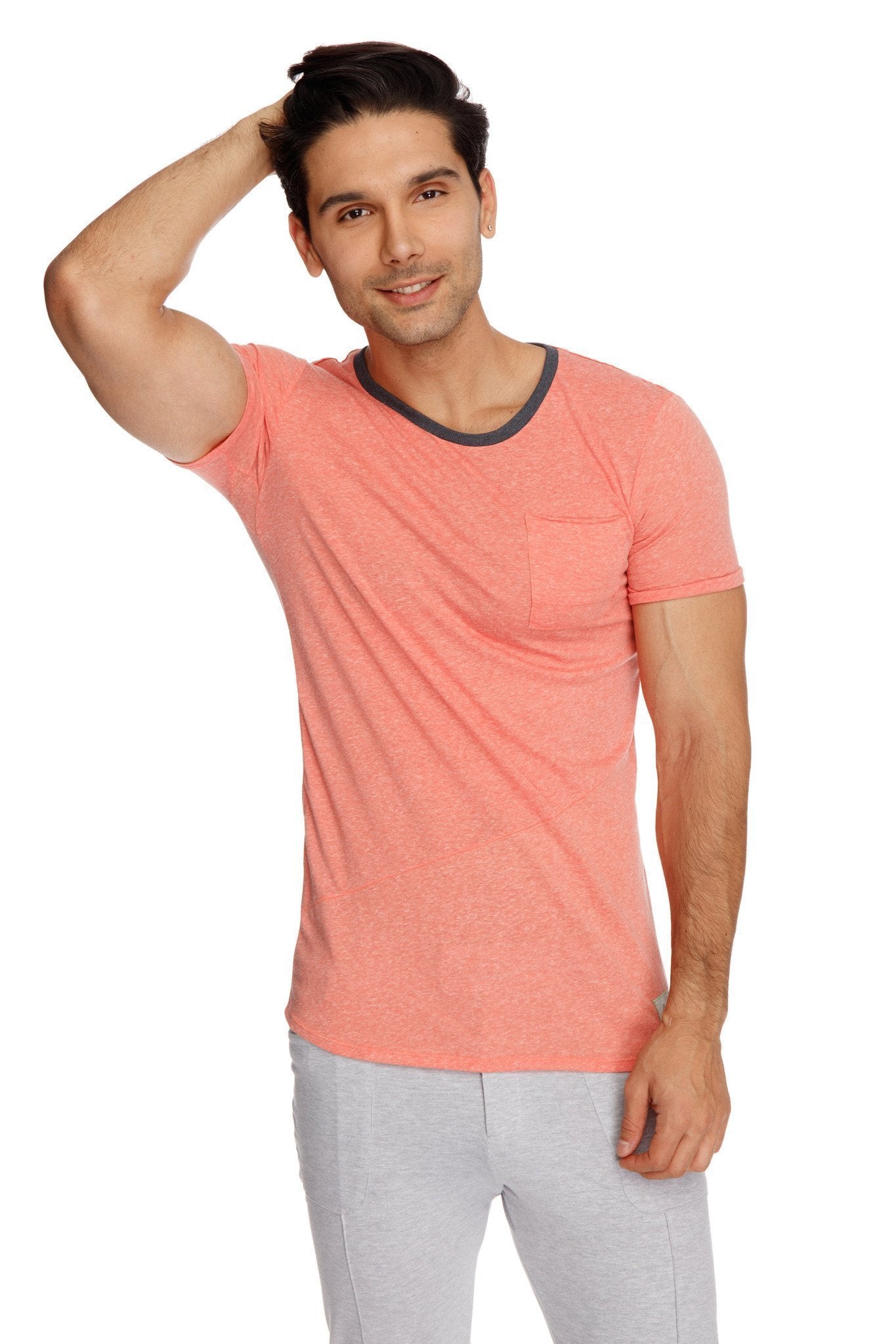 Coral short-sleeved t-shirt with dark gray ribbed crew neckline and chest pocket paired with heather grey tactical urban yoga pants