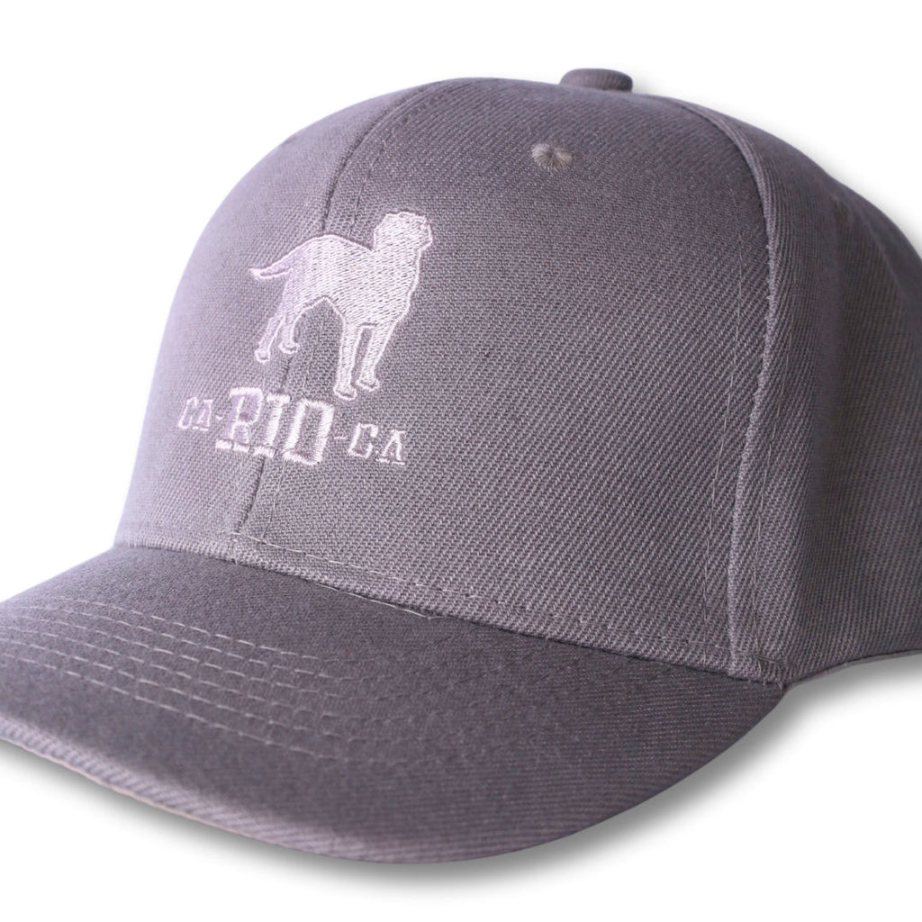 Gray baseball cap with a white embroidered dog silhouette and ca-rio-ca text in the stealth ca-rio-ca logo hat design