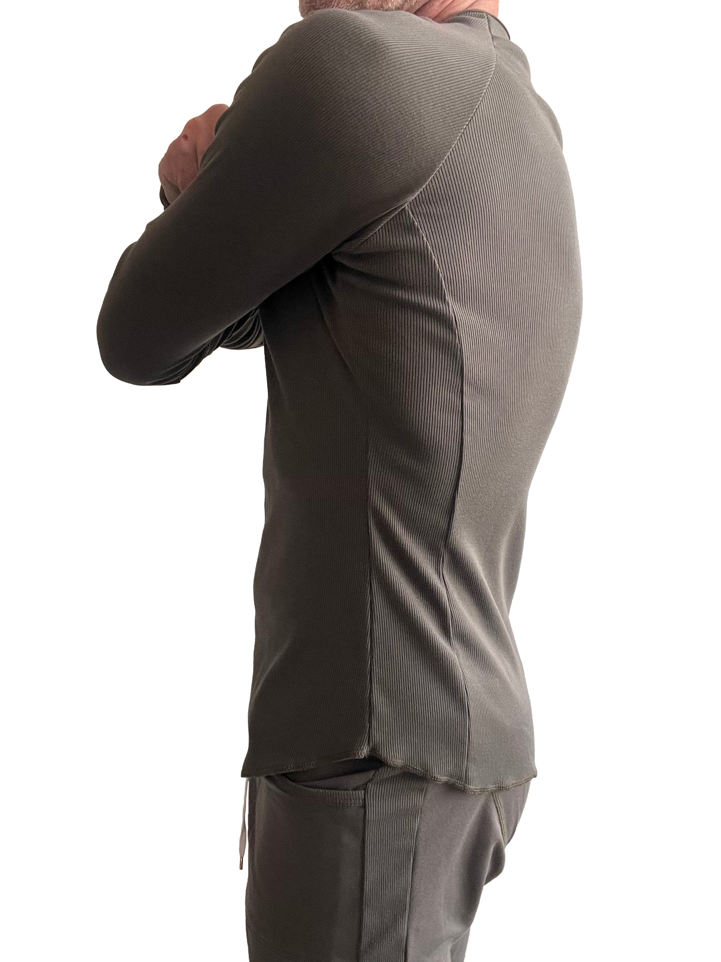 A sleek olive green thermal v neck long sleeve top with ribbed fabric and tailored fit featuring side seam detailing