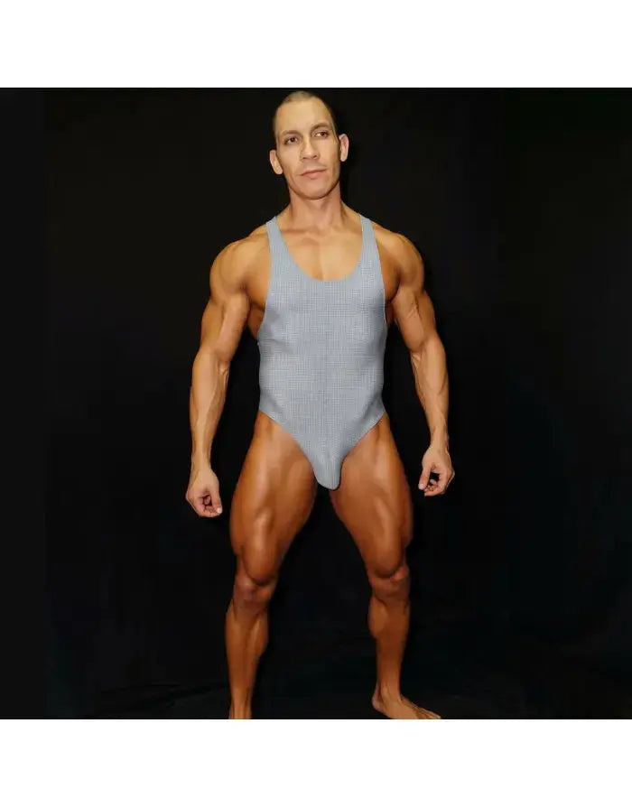 Grey ribbed bodysuit with thong cut showcasing a muscular model by Arroyman.