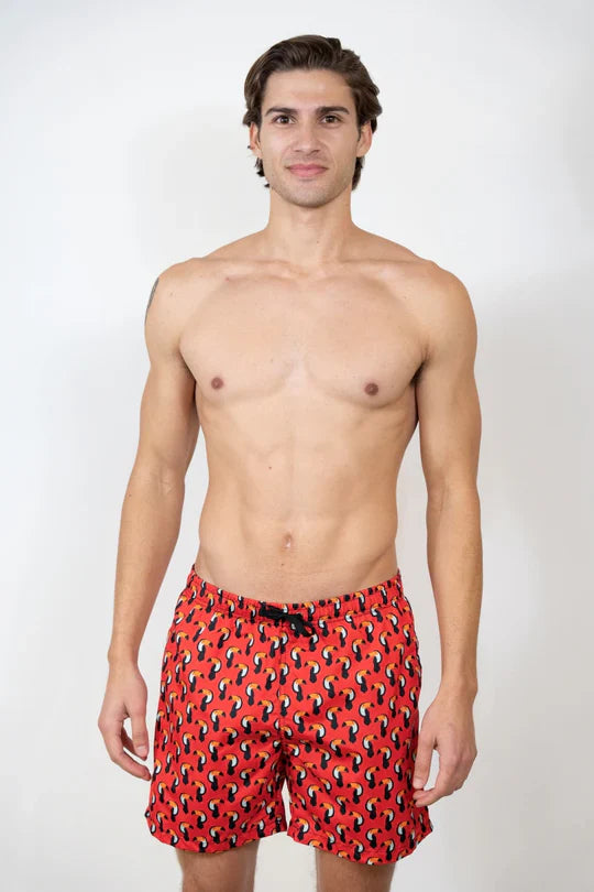 Red toucan print swim short with black and yellow abstract pattern designed for swimming and beachwear