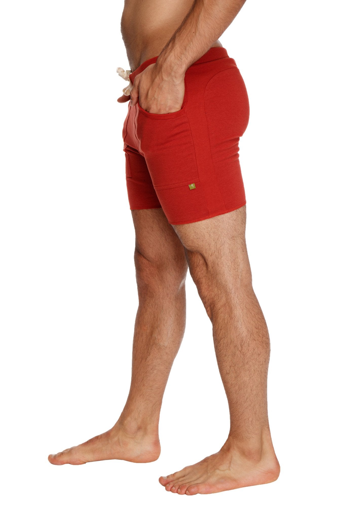 Red transition yoga shorts with drawstring waist and side pockets designed for athletic use in cinnabar red
