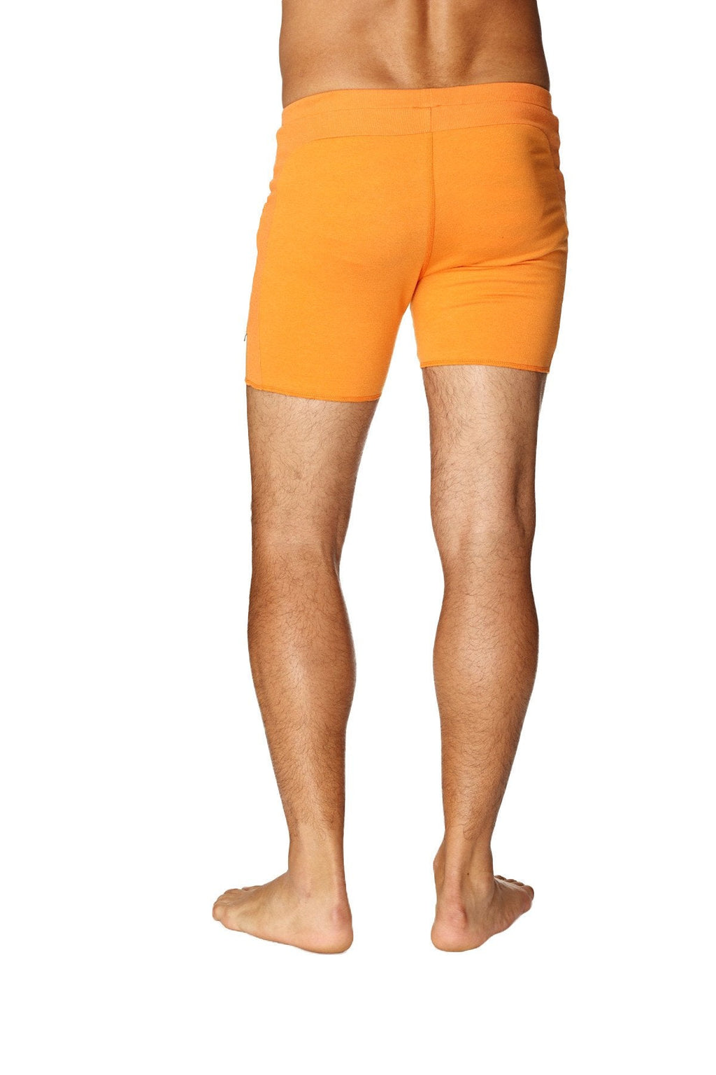 Orange athletic transition yoga shorts with snug fit and elastic waistband in sun orange color