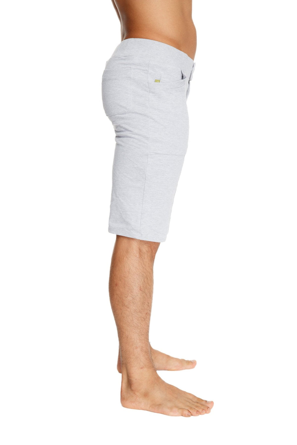 Back view of urban tactical at home dress shorts in heather grey light gray denim with subtle green logo on pocket