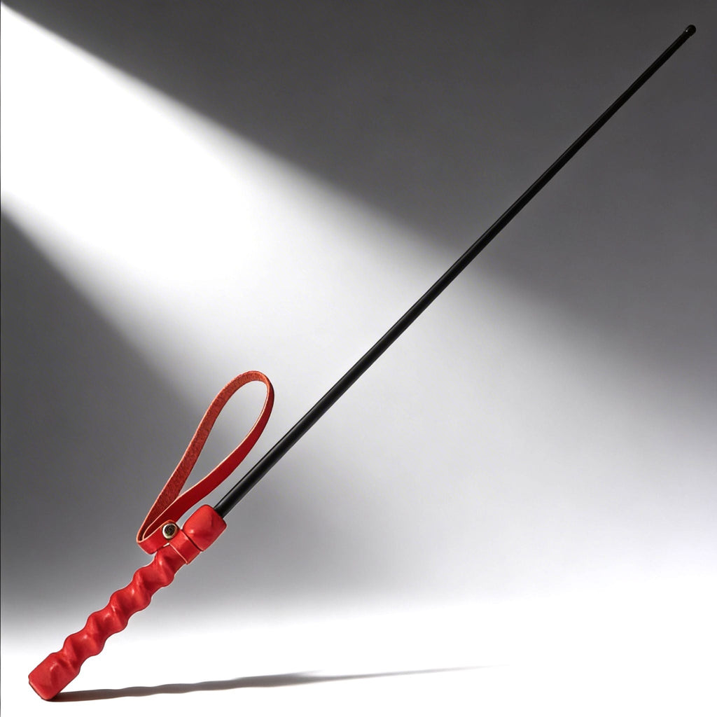 Kink Industries The Intense Impact Cane features a long, thin black shaft with a vibrant red, textured grip and loop.