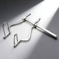 Kink Industries silver metal anal spreader with an adjustable sliding mechanism and two arched insertion prongs.