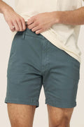 Warp + Weft Denim Act Chino Short in dark teal, styled with a light-colored t-shirt.