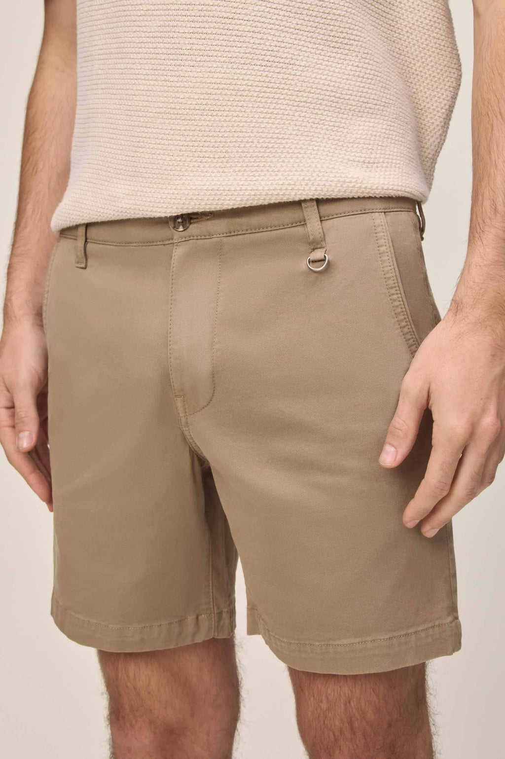 Warp + Weft Denim Act Chino Short in khaki with a D-ring on the belt loop, paired with a beige knit top.