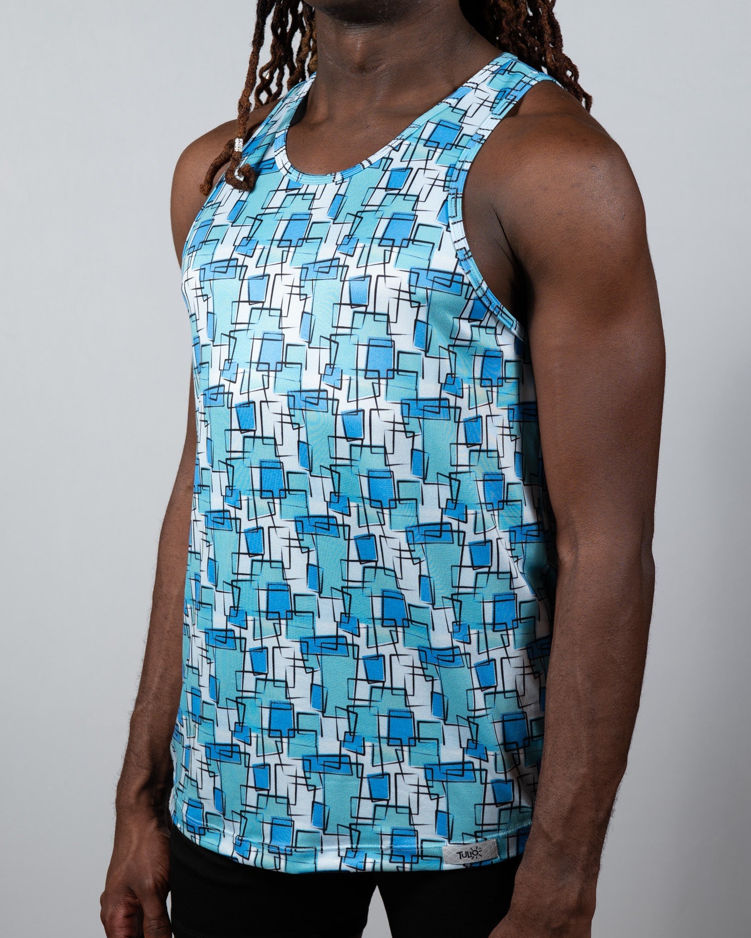 A men’s wallpaper print tank top with overlapping blue squares on white lightweight fabric