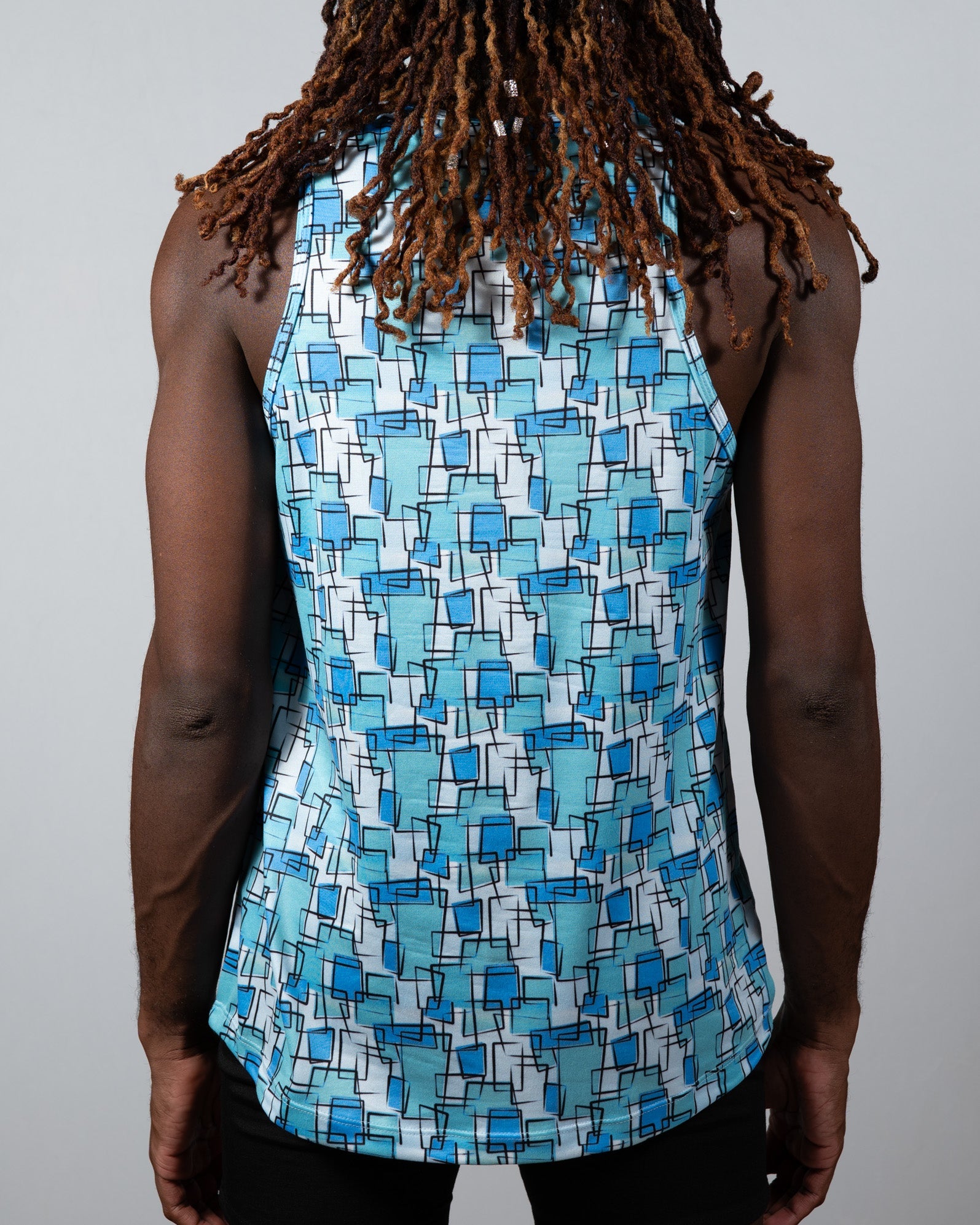 A blue and white sleeveless tank top with geometric wallpaper print perfect for casual summer wear