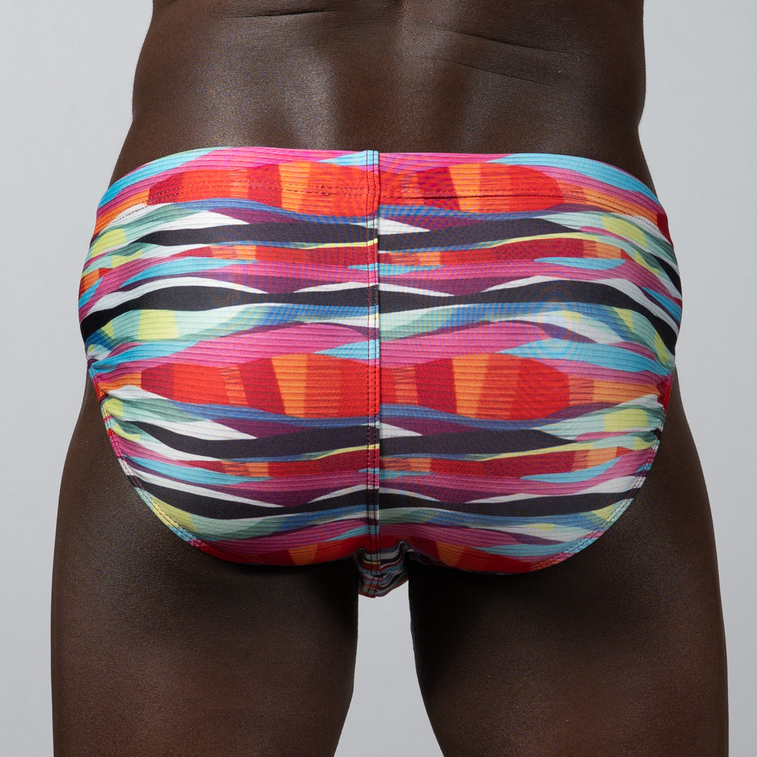 Waves Print Brief vibrant multicolored swim trunks with bold abstract stripes in pink orange blue and black