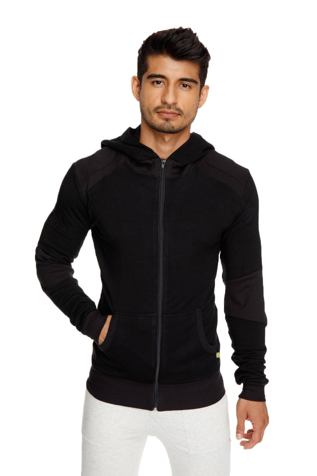 Black mid-weight luxury-fleece form-fit crossover yoga track hoodie with dark shoulder panels and yellow hem tag