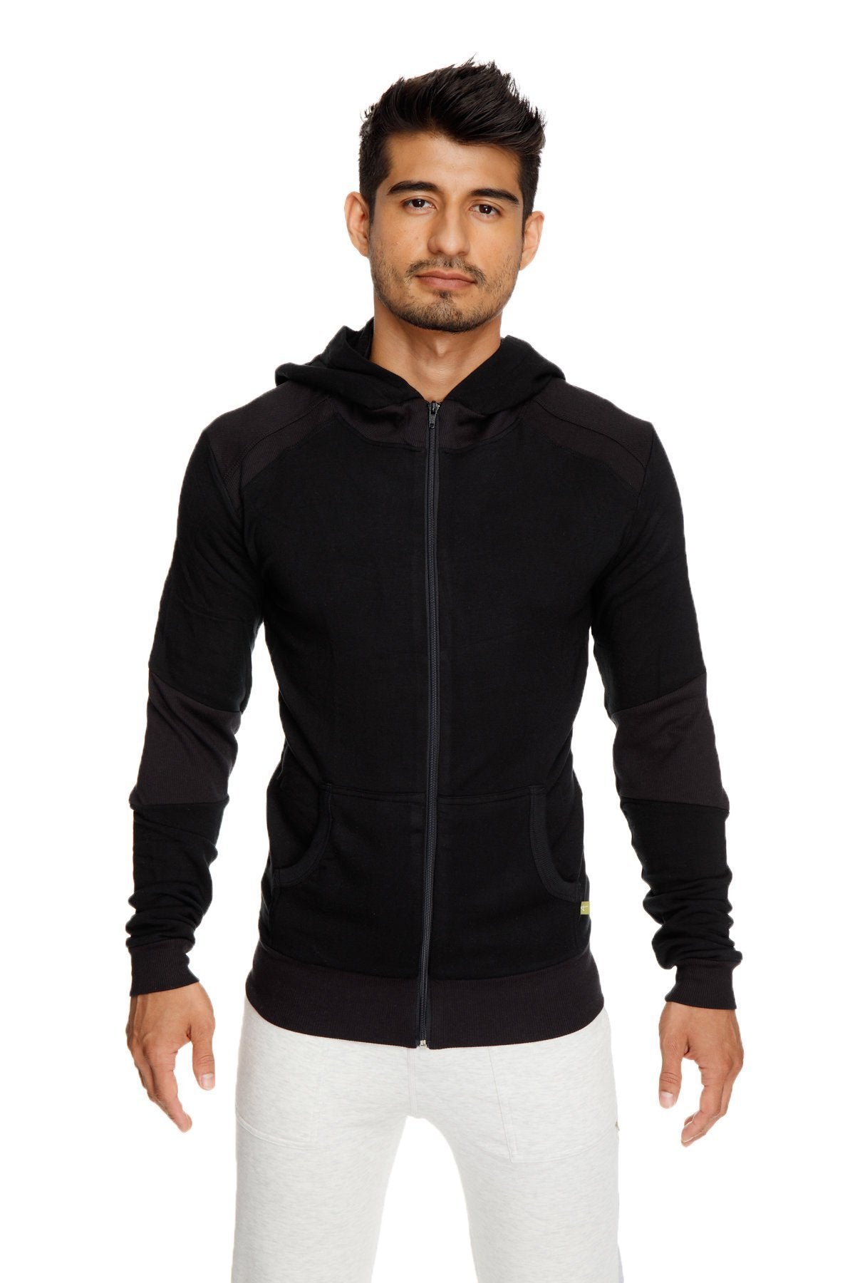 Black mid-weight luxury fleece zip-up hoodie with subtle contrast sleeve panels and yellow tag for yoga trackwear