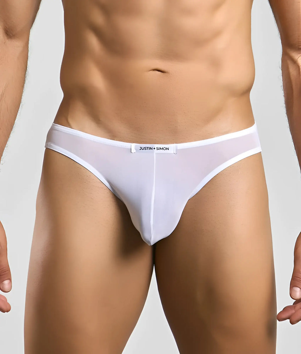 White sheer mesh briefs with a white waistband featuring the justin + simon brand label in classic mens bikini mesh style